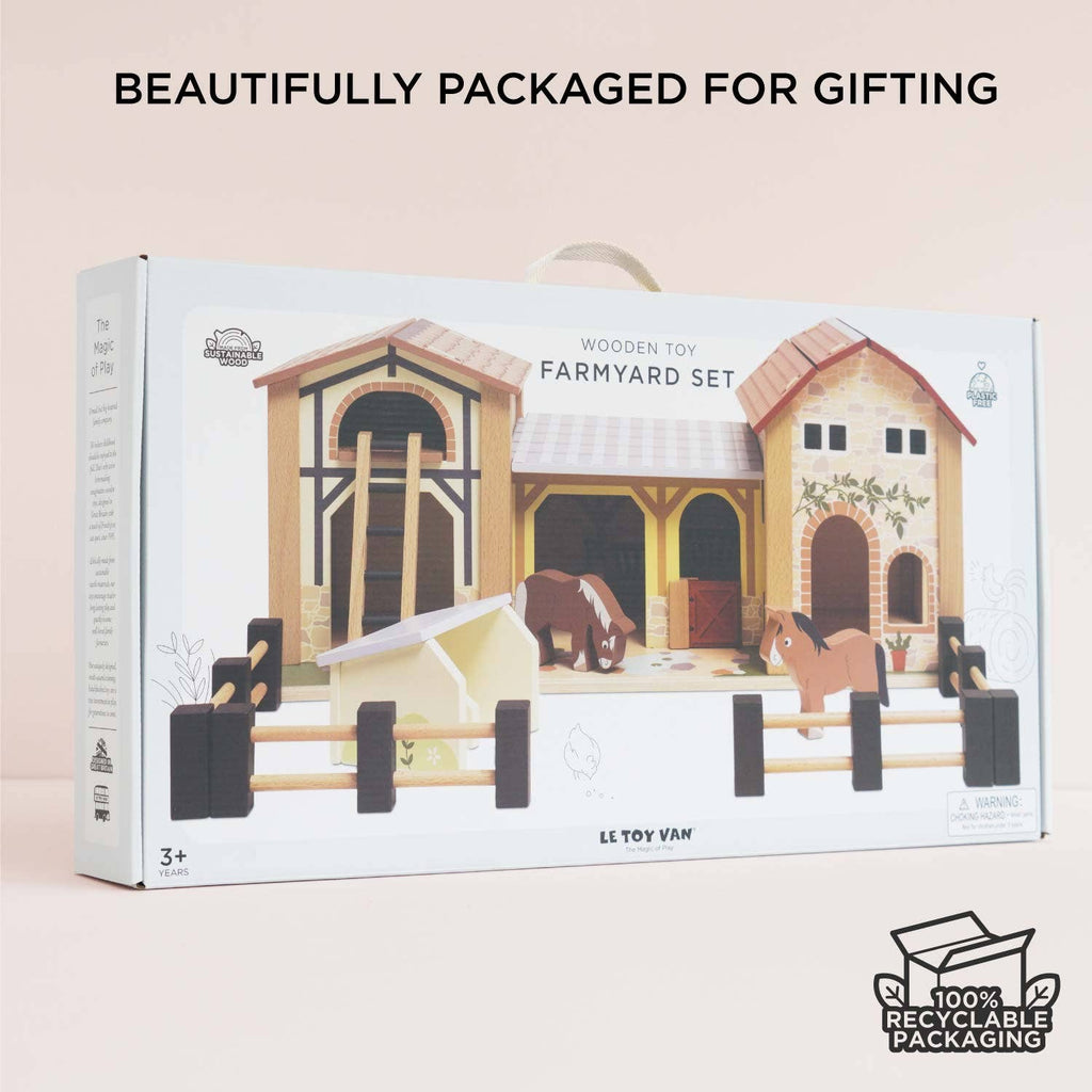 The Wooden Farmyard Stables by Le Toy Van features animals and buildings crafted from FSC-certified wood. Perfect for kids 3+, it comes in 100% recyclable, gift-ready packaging—ideal for small world play.