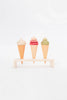 Three Handmade Ice Cream Cone toys, handcrafted in Ukraine and displayed on a stand against a white background. From left to right: vanilla, strawberry, and matcha flavors.