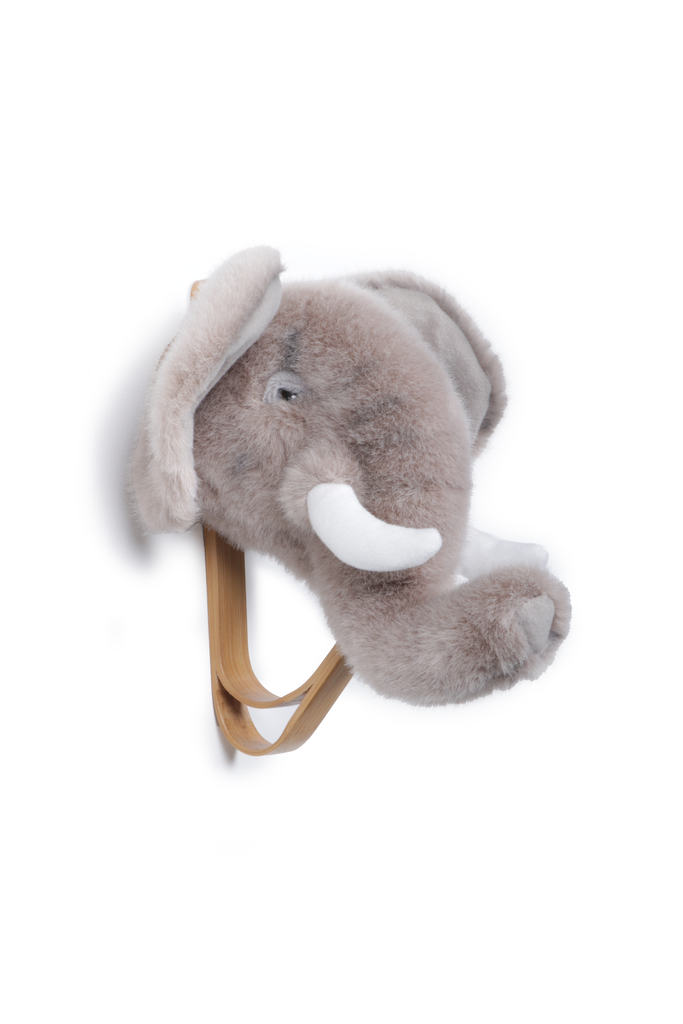 The Coat Hanger - Elephant features a plush gray elephant head with white tusks mounted on an animal wall hook, shown against a white background.