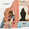 A young child plays at the Tabletop Puppet Wooden Theater, handing tickets through the window to two plush mouse toys. The booth features colorful curtains and a "THEATRE" sign, sparking imaginative play.