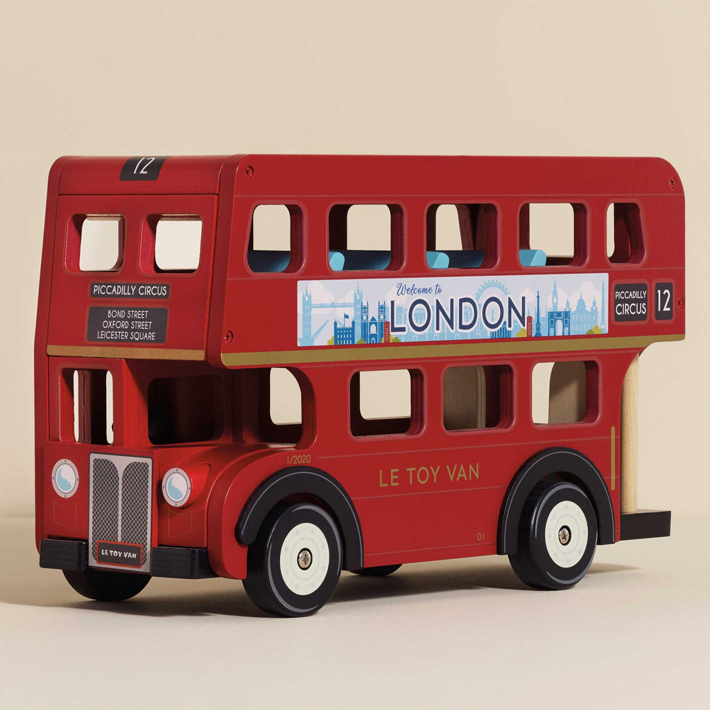 The London Wooden Bus is a red wooden toy featuring "LE TOY VAN" on the side, a "Welcome to London" banner, black wheels, and realistic route and destination signs—designed as a charming early learning toy with classic London bus details.