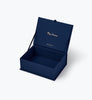Open dark blue Nativity Large Embroidered Keepsake Box with “Merry Christmas” and a brand name printed in gold on the inside lid.