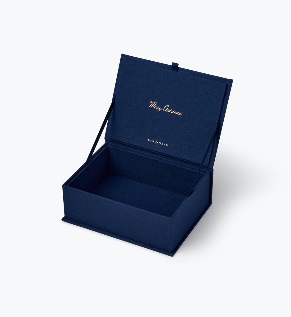 Open dark blue Nativity Large Embroidered Keepsake Box with “Merry Christmas” and a brand name printed in gold on the inside lid.
