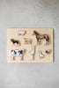 Farm Animals Wooden Puzzle: A Tabitha Paige Puzzle features a wooden puzzle board with removable animal pieces—a pig, dog, horse, cow, alpaca, duck, chicken, and cat—arranged on a light surface. This charming farm animal puzzle is an ideal toddler educational toy and classic wooden peg puzzle that encourages fine motor skills and early learning through play.