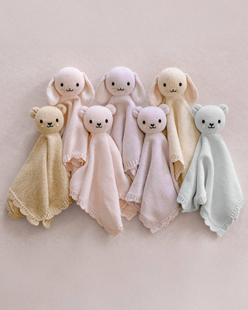 The Cuddle + Kind Organic Cotton Baby Bunny Lovey (Oatmeal) is a soft, pastel-hued, fair trade blanket with a plush bunny head—perfect as a cozy and thoughtful organic baby gift.