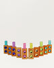 Eight Bauspiel Gem Blocks with Pastel Lucent Cubes arranged in a curve, each embedded with two translucent colorful gems and topped with a matching acrylic cube.