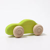 A Grimm’s Wooden Cars Slimline, painted green with natural wood wheels and finished with smooth natural oils, is set against a plain white background.