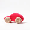 Grimm's Colored Wooden Cars—simple red wooden toy cars with natural wood wheels, designed for safe, non-toxic play—are shown on a plain white background.
