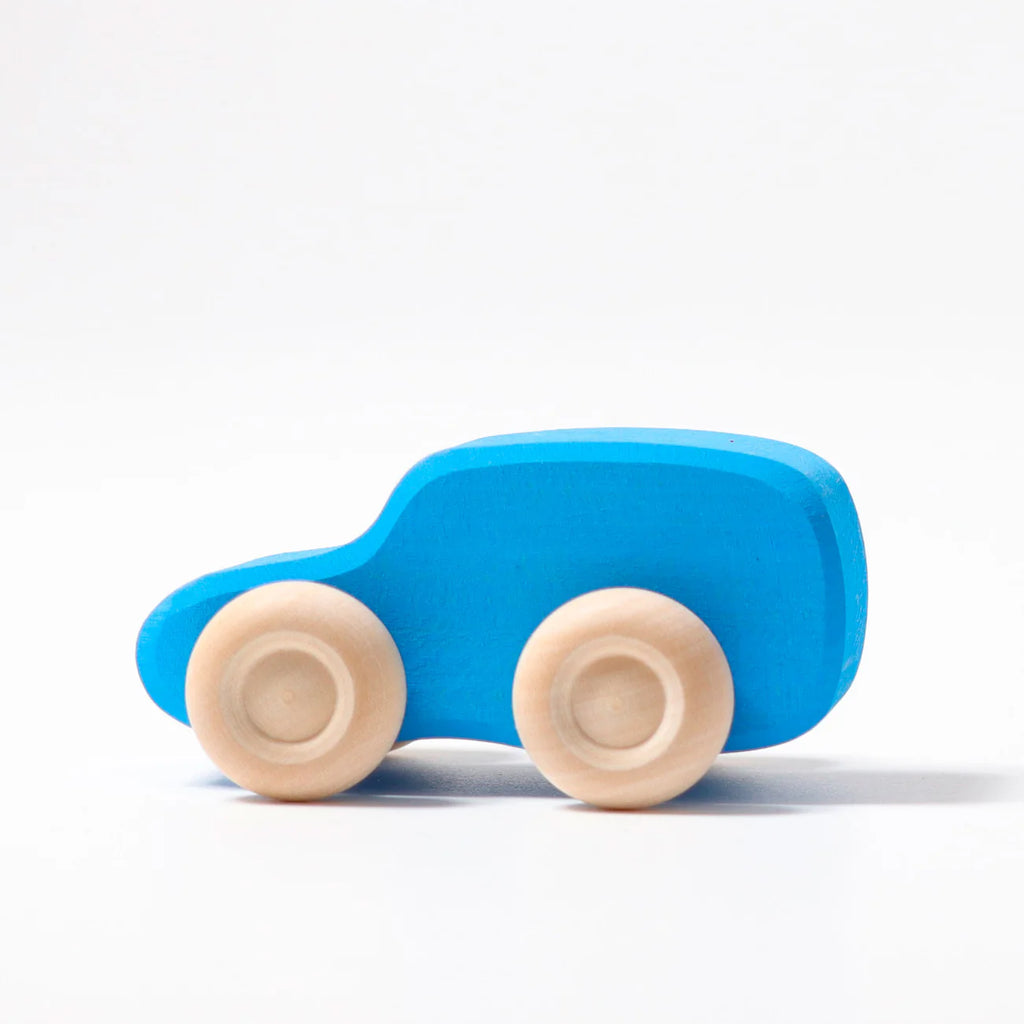 A simple blue Grimm's Colored Wooden Car with four light wooden wheels, inspired by Grimm's Cars, photographed on a white background.