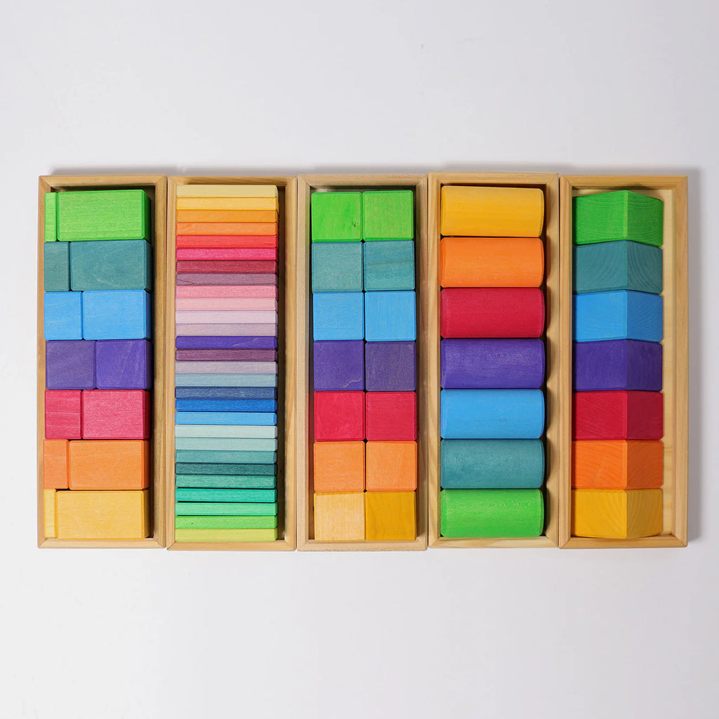 Grimm's Shapes and Colors Set features four stacking wooden frames filled with colorful geometric blocks, neatly sorted by color—ideal for developing fine motor skills and encouraging organized play.