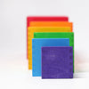 Grimm's Large Set of Boxes - Rainbow features five non-toxic wooden boxes in purple, blue, green, yellow, and red standing upright in a row on a white background, each one slightly overlapping for a delightful rainbow display.