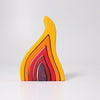 The Grimm's Fire Stacker consists of colorful, curved wooden pieces primarily in shades of yellow, orange, and red, arranged in an abstract, branching pattern against a white background. This charming wooden stacking toy also features a small purple piece shaped like a truncated cone placed in the foreground.