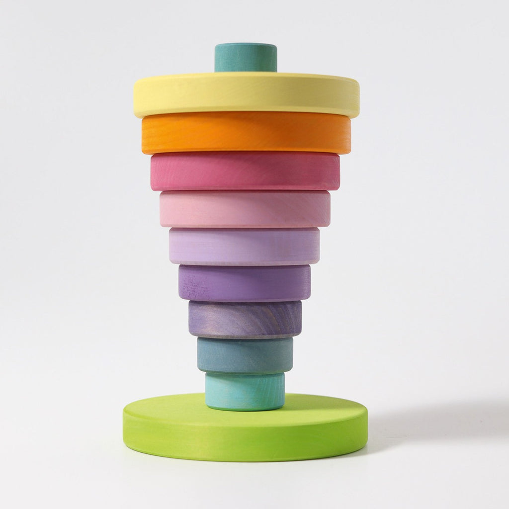 A Pastel Stacking Tower with nine circular discs of varying sizes, arranged from largest on the bottom to smallest on top, in shades of green, blue, purple, pink, orange, and yellow. Perfect for developing fine motor skills and eye-hand coordination on a vertical rod with a green base.