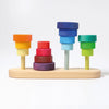 Grimm's Fabuto Stacker: a wooden stacking toy with vibrant red, yellow, blue, and green disks on four pegs atop a light wood base—ideal for color coordination and classic play.