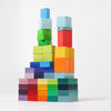 Grimm's Color Charts-Rally features colorful building blocks stacked in tall, uneven towers and rows, creating a vibrant display against a plain white background.
