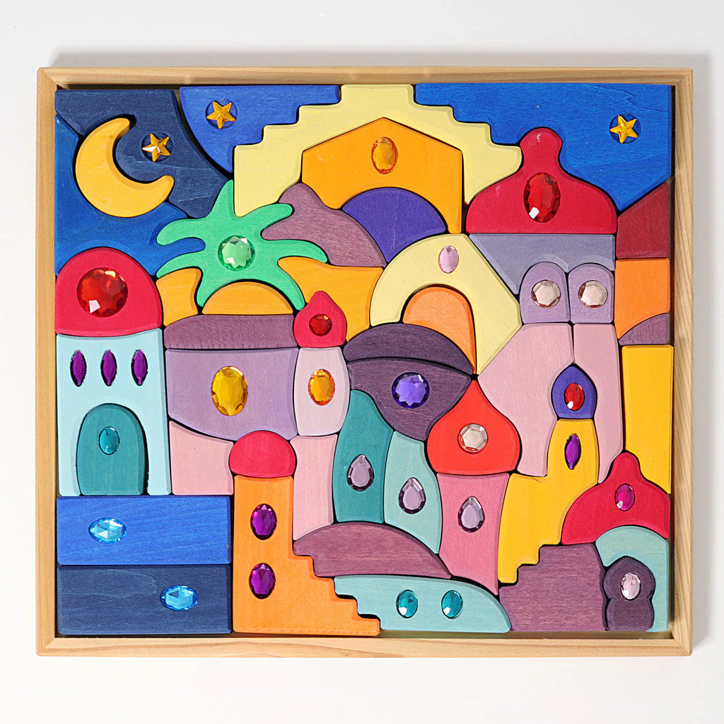 Grimm's Sparkling Mandala Orient is a colorful wooden puzzle featuring domed buildings, arches, and towers. Its gem-decorated blocks create a whimsical cityscape, evoking an enchanting night under the stars. Ships in 1-2 weeks.