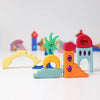 Grimm's Sparkling Mandala Orient features colorful glitter wooden blocks in shapes like arches, stairs, and abstract forms, some with sparkling mandala decorations. Creatively arranged on a white background. Ships in 1-2 weeks.