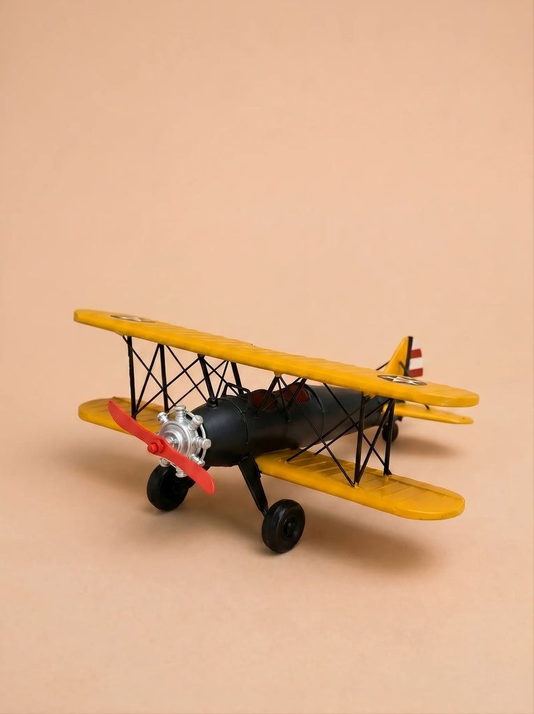 Little Forest Animals — The Aviator, a small model biplane featuring yellow wings, a black body, and a red propeller, is displayed on a beige background.