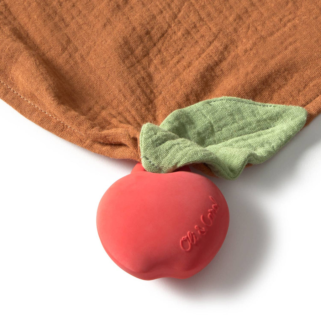 Pepa the Apple Big Doudou is a red, apple-shaped natural rubber teether embossed with "Oli&Carol," attached to a brown organic cotton baby doudou and a green leaf-shaped cloth napkin—an ideal comfort toy for little ones.