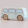 The No. 29 GT160 Daisy, a light blue and white vintage wooden campervan with simple painted details and wooden wheels, is showcased on a neutral background, evoking the charm of nostalgic play. Made in England.