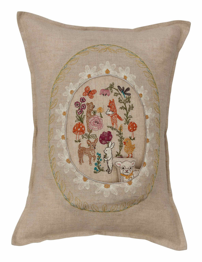 The Sugar Egg Pocket Pillow is a square beige pillow with intricate embroidery depicting an Easter wonderland of animals, flowers, and mushrooms. The central design includes a fox, rabbit, and bear among butterflies, bordered by an ornate metallic gold leaf embroidery.