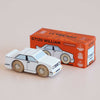 A small No. 21 GT120 William wooden racing car, made in England and painted white, sits in front of its orange box, which displays an illustration of the car and the text “GT120 WILLIAM Limited Edition.”.