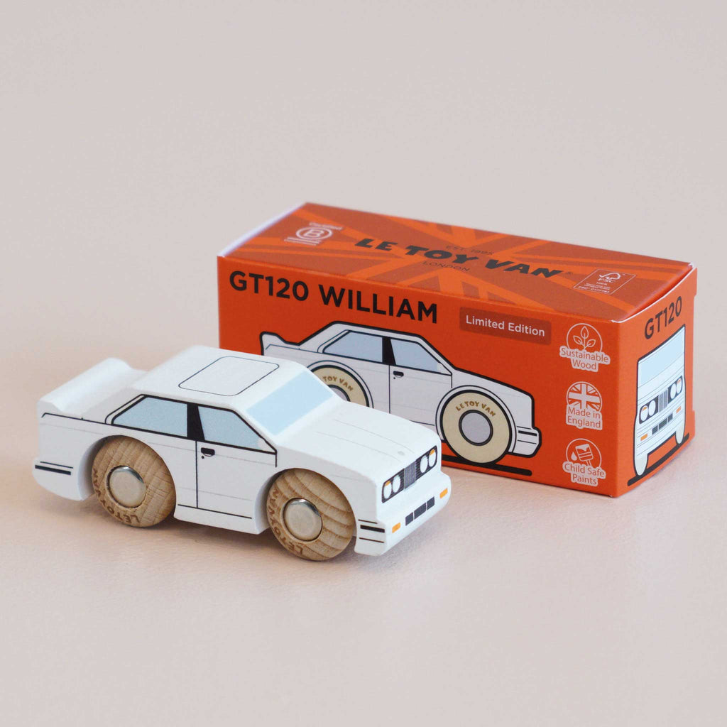 A small No. 21 GT120 William wooden racing car, made in England and painted white, sits in front of its orange box, which displays an illustration of the car and the text “GT120 WILLIAM Limited Edition.”.