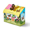 The Magical Minds Garden Kit comes in a vibrant box with cartoon butterflies, flowers, and a whimsical house. This kids' gardening kit features a pop-up butterfly and cheerful text about growing flowers for pollinators.