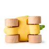 Lou The Lemon Baby Car, an eco-friendly yellow sensory play car with four wooden wheels, is seen from underneath against a white background. Partially visible green accents on top enhance its playful lemon-inspired design.