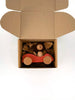 A cardboard box with brown packing paper holds the Sabo Concept Car with Lion—a wooden toy figure in a natural wood car—seen from above on a white background, inspiring imaginative play.