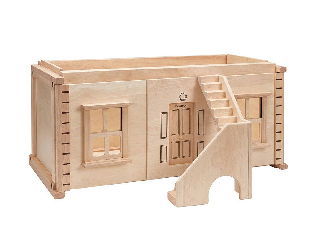 The PlanToys Victorian Dollhouse Basement Floor features an open design with etched doors and windows, an attached right-side staircase, and a natural wood finish. It’s compatible with PlanToys Victorian Dollhouse accessories.
