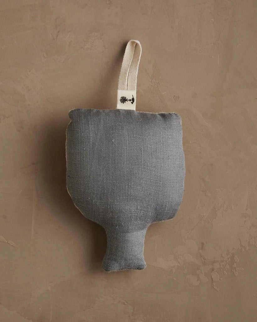 The Coral & Tusk Togetherness Deer Ornament is a small, gray, textured fabric decoration with a cream loop, shaped like a goblet or trophy, attached to a neutral wall—an ideal woodland holiday accent for your seasonal décor.