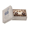 A wooden 1930s car, made from FSC certified wood, inside an open, decorative box with shredded filler, labeled "wooden story peace & love car" in vintage-style packaging.