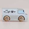 A charming small wooden coffee van, named No. 11 GT65 Coco and made in England, features a light blue finish with “Café” and a teacup graphic on the side. Complete with sturdy wooden wheels and playful, minimal detailing, it’s perfect for imaginative storytelling or as a thoughtful gift.