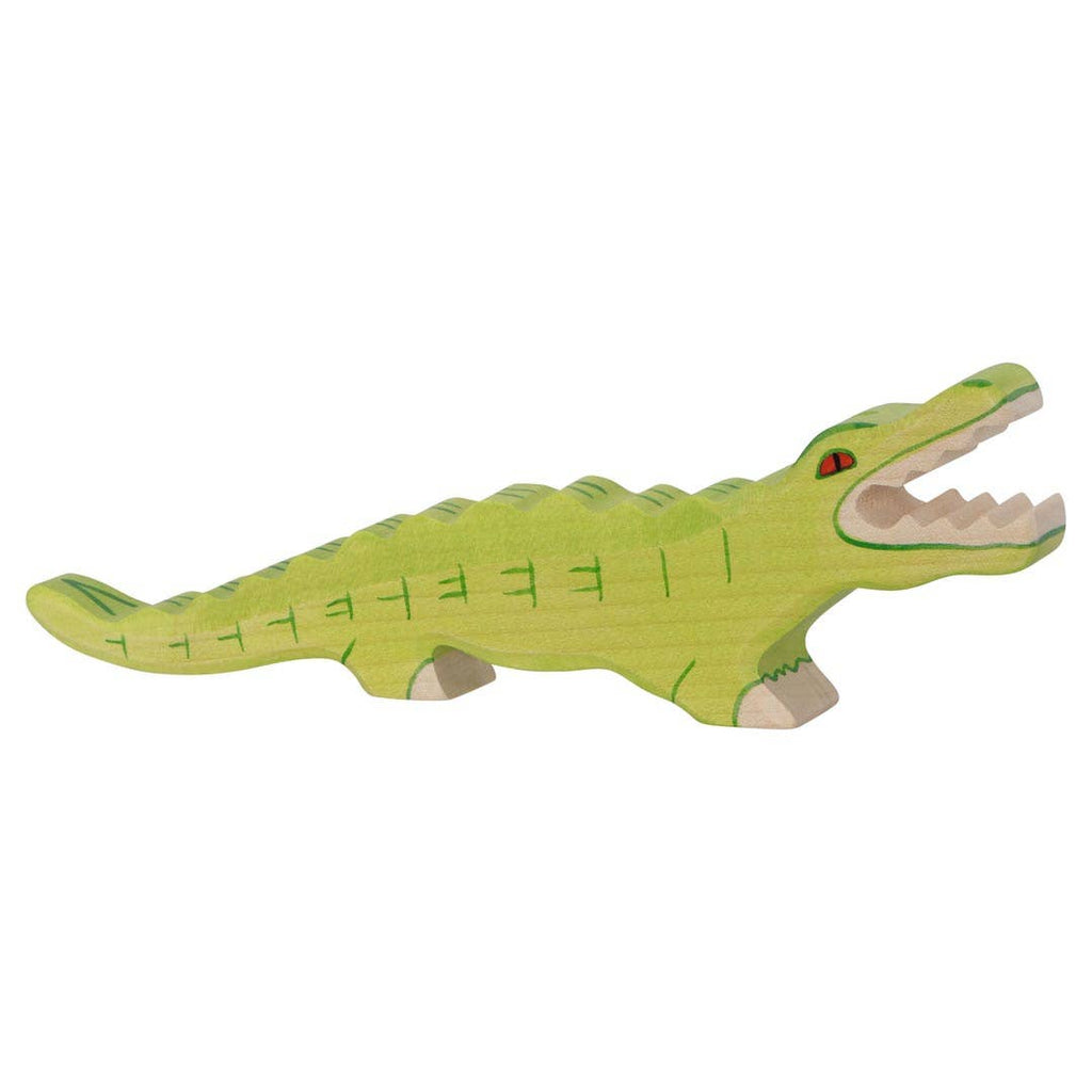 The Holztiger Crocodile is a handcrafted wooden toy made in Europe, painted light green with minimal facial features, red eyes, and an open mouth showing white teeth. Its smooth finish highlights Holztiger's quality craftsmanship.