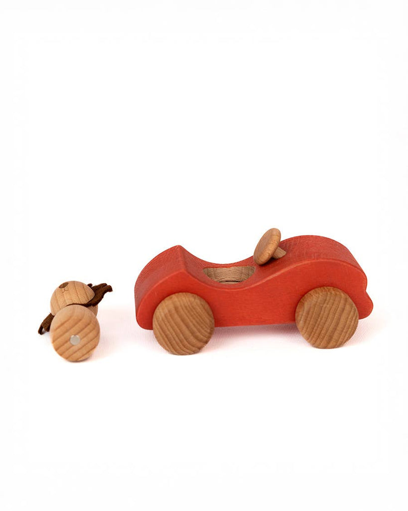 The Sabo Concept Car with Lion, a small red wooden car with round wooden wheels, sits on a white background ready to inspire imaginative play.