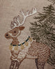An embroidered reindeer wearing a bell collar stands next to an evergreen tree on this Coral & Tusk Christmas Cheer Lumbar Pillow.