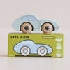 A light blue vintage wooden car, the No. 2 GT15 Jude made in England, sits atop a green box labeled “GT15 JUDE.” The box showcases a car illustration and icons highlighting sustainable wood, child-safe paints, and its English craftsmanship—making it a charming gift for kids.
