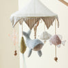 The Nautical Dreams Mobile hangs from the ceiling with plush sea shapes—whale, shell, fish, and star. Neutral tones with pastel accents and wood beads make it perfect nursery decor.
