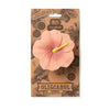 Iris the Hibiscus Teething Toy by OLI & CAROL Garden is a pink, hibiscus-shaped natural rubber teether and bath toy with a yellow stamen, displayed on brown botanical-themed packaging labeled "IRIS THE HIBISCUS.