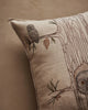 A close-up of the Coral & Tusk Owl Family Tree Pillow, showcasing embroidered owls on a tree branch, with detailed pine cone and trunk accents on a neutral background.