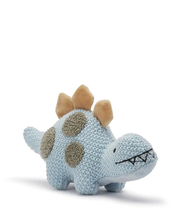 The Baby Dinosaur Stuffed Animal is a soft, knitted blue dinosaur toy adorned with a row of tan triangular spikes along its back and green sensory spots on its body. Its embroidered eyes and mouth give it a friendly and cute appearance. Perfect as a newborn gift, the toy is posed against a white background.