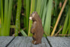 A small Handmade Holzwald Small Bear - Standing figurine shown in profile.