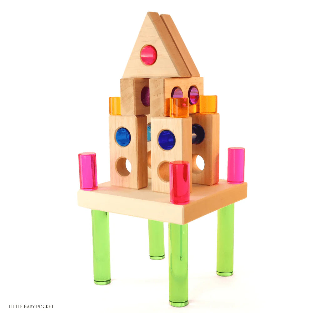 The Bauspiel Luminous Pillars feature colorful wooden blocks with circular cutouts and transparent plastic in pink, orange, blue, and green. Resembling a playful castle on four green legs, this delightful creation highlights the charm of educational toys.