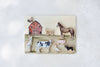 Introduce your child to classic farmyard friends with the Farm Animals Wooden Puzzle: A Tabitha Paige Puzzle. Featuring a red barn along with a horse, cow, pig, lamb, dog, rooster, duck, and llama on a subtly textured light background, this charming peg puzzle is the perfect toddler educational toy for helping little hands learn about animals and shapes.