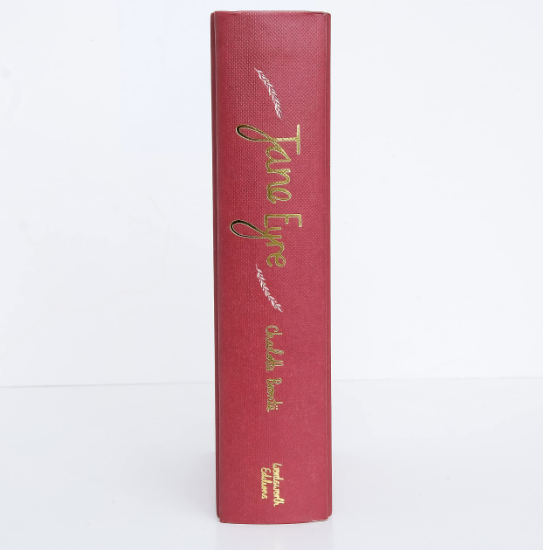 A red hardcover Jane Eyre Collector's Edition by Brontë, with "Jane Eyre" in gold and green on the spine and "Wordsworth Editions" at the bottom, stands upright against a white background.