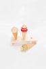 Two Handmade Ice Cream Cones and a toy popsicle, all coated with non-toxic water-based paint, displayed on a minimalist wooden stand against a white background.
