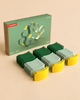 The WaytoPlay: Arches - Builder Set box is displayed on a beige background, accompanied by 24 curved toy track pieces in green, light green, and yellow neatly arranged in rows. Made from sustainable recycled plastic, this creative construction set offers hours of imaginative play.
