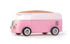 The VW Beach Bus Pink is a toy Volkswagen Type 2 van in pink and white, featuring a wooden roof, magnetic camper top, black wheels, and a VW logo on the front, shown on a white background.