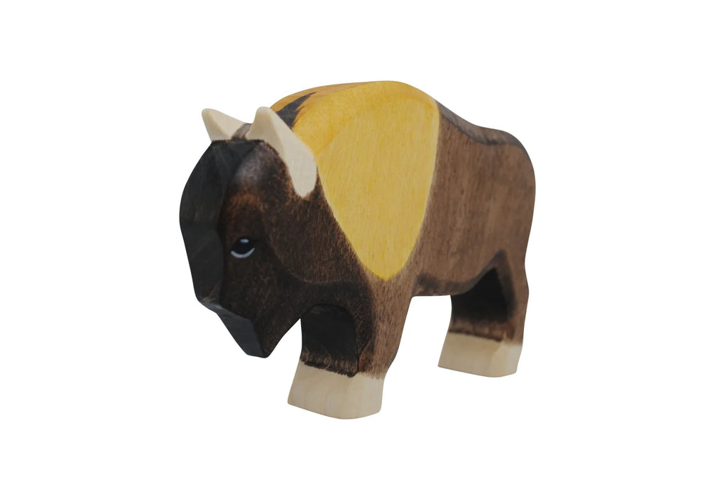 The Handmade Holzwald Bison is a sustainable wooden toy, painted brown with a yellow back patch and cream-colored horns and hooves, shown on a white background.